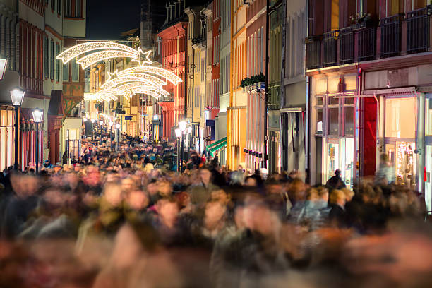 Shopping hustle in Germany Large crowd of people hustling and shopping in a pedestrian area in Heidelberg, Germany, for Christmas heidelberg germany photos stock pictures, royalty-free photos & images