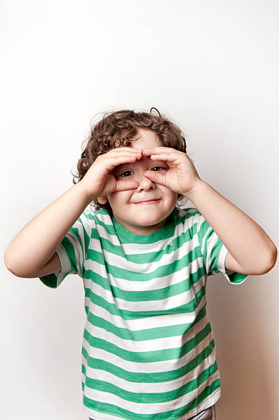istock Portrait of a cute boy making binoculars with his hands 624126880