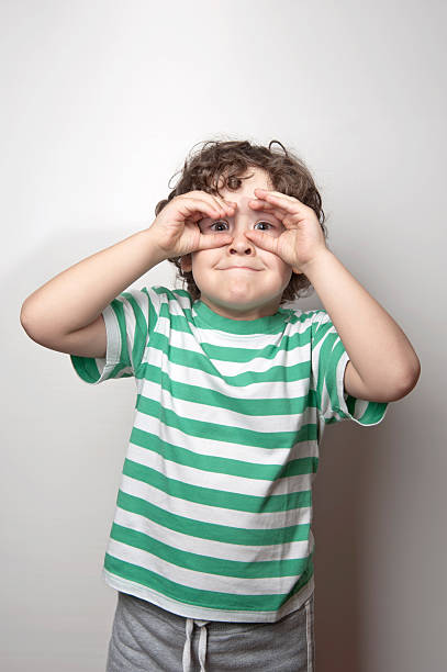 istock Portrait of a cute boy making binoculars with his hands 624127084