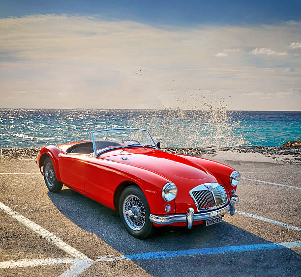 Cascais, Portugal, August 29, 2015 Classic red mg a roadster parked at a car show, showcasing its rear design, including a luggage rack and spoked wheels