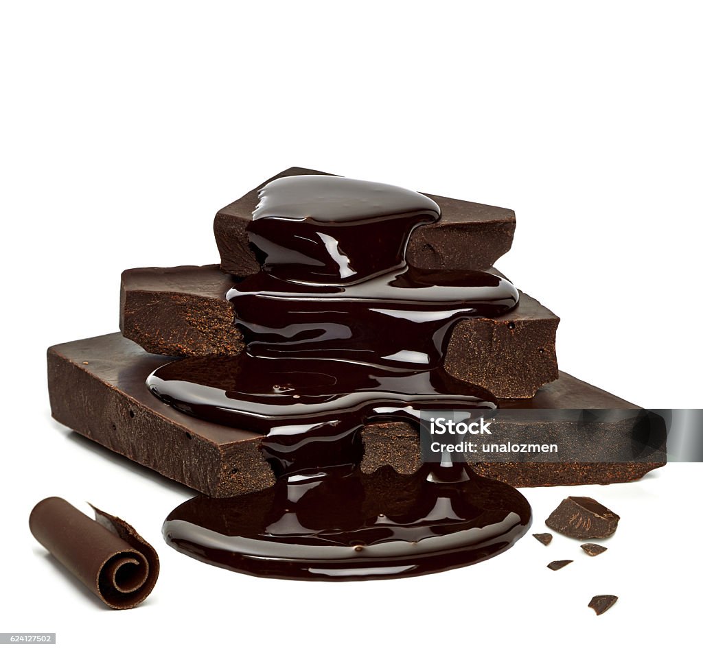Chocolate sauce over cracked chocolates Chocolate sauce flow over cracked chocolate blocks on white background Chocolate Stock Photo