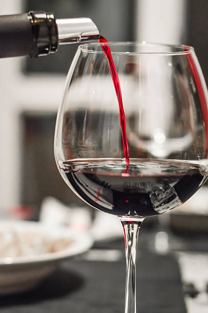 istock serving a glass of red wine close up 624127928