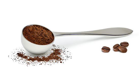 Coffee scoop with coffee beans isolated on white background including clipping path.