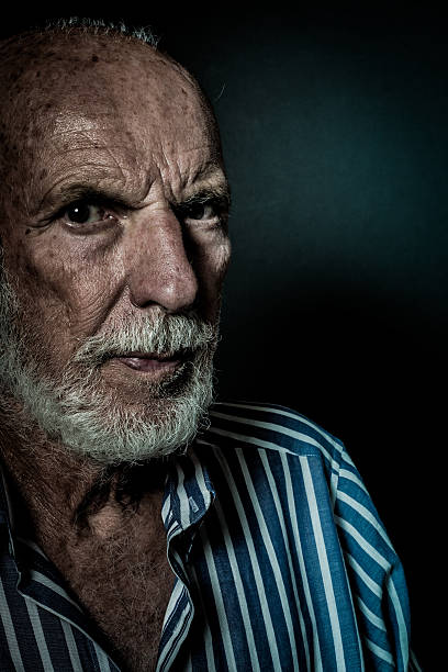istock Senior Man Portrait, beard,  facial expression, black background 624131648