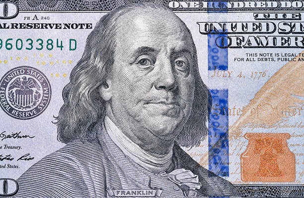 istock One hundred dollar bill fragment closeup 624139964