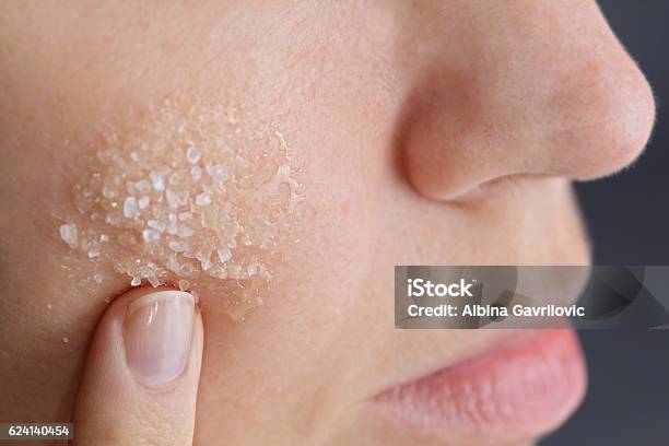 Woman Applying Homemade Facial Scrub From Honey And Sea Salt Stock Photo - Download Image Now