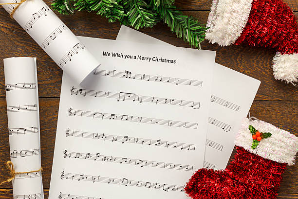 istock Christmas music note paper with Christmas decoration on table background. 624141460