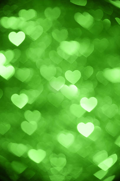 istock green heart bokeh background photo, abstract holiday backdrop 624147496