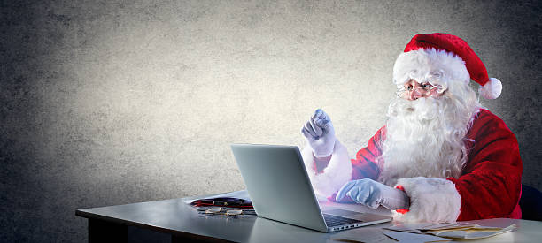 istock Santa Claus Writing With Laptop 624148534