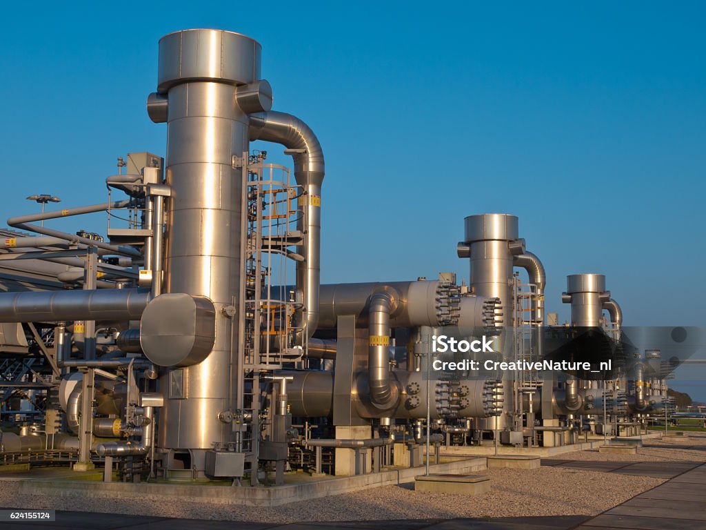 Modern natural gas processing plant A modern natural gas processing plant during sunset Natural Gas Stock Photo