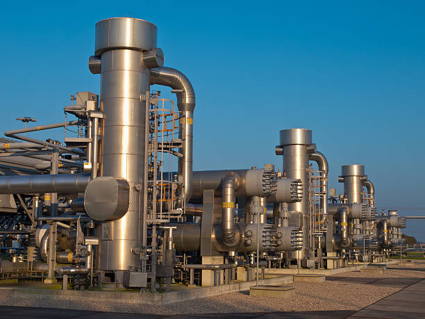 Modern natural gas processing plant A modern natural gas processing plant during sunset compressor stock pictures, royalty-free photos & images