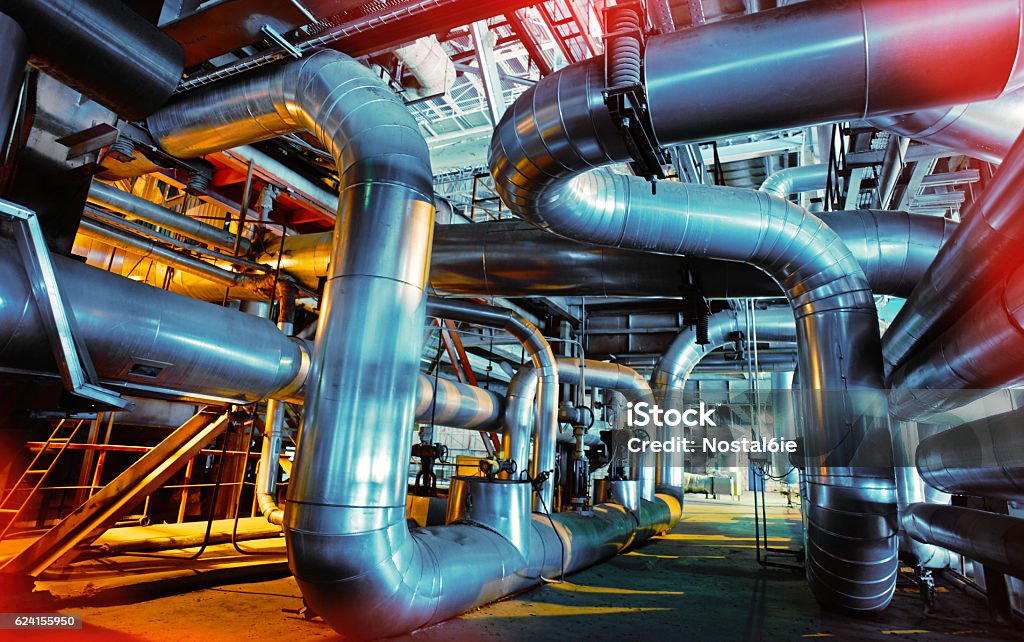 Industrial zone, Steel pipelines and valves Equipment, cables and piping as found inside of a industrial power plant Chemical Plant Stock Photo