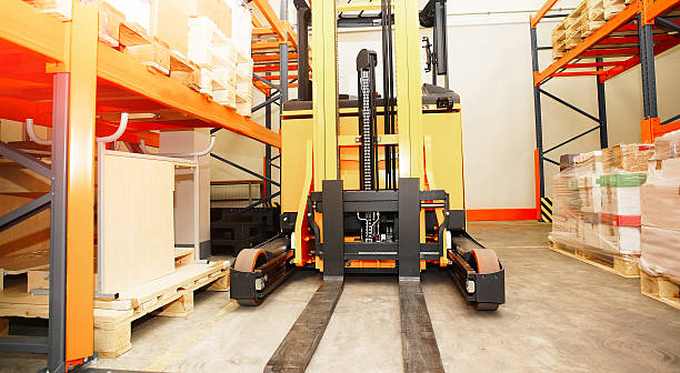 istock Forklift, shelves and racks with pallets in distribution warehou 624156732