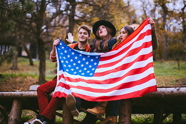 istock Shiny Cheerful People Holding an American Flag 624157568