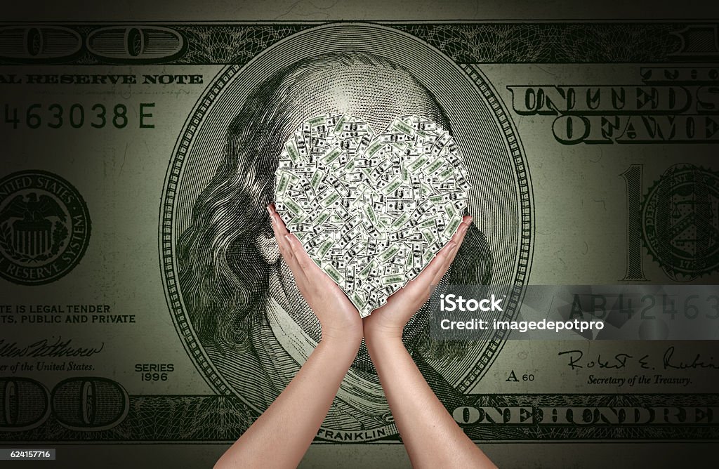 love to make money hands holding heart shaped one hundred dollar bills over one hundred dollar bill American One Hundred Dollar Bill Stock Photo