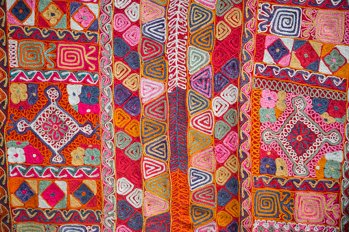 Stack of colorful, traditional Peruvian fabrics. Tourist's market in Chinchero village, Sacred Valley, Peru.The Sacred Valley of the Incas or Urubamba Valley is a valley in the Andes  of Peru, close to the Inca capital of Cusco and below the ancient sacred city of Machu Picchu. The valley is generally understood to include everything between Pisac  and Ollantaytambo, parallel to the Urubamba River, or Vilcanota River or Wilcamayu, as this Sacred river is called when passing through the valley. It is fed by numerous rivers which descend through adjoining valleys and gorges, and contains numerous archaeological remains and villages. The valley was appreciated by the Incas due to its special geographical and climatic qualities. It was one of the empire's main points for the extraction of natural wealth, and the best place for maize production in Peru.http://bem.2be.pl/IS/bolivia_380.jpg