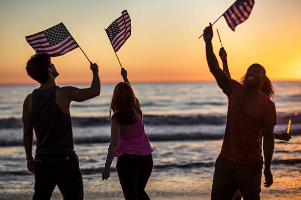 istock Group of young people celebrating on the beach 624161542