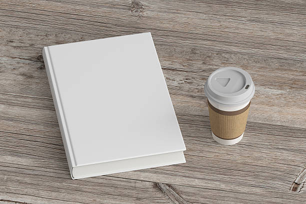 istock Blank book cover and coffee drinking cup. 624169328