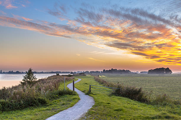 holland landscape with winding cycling track - polder field meadow landscape imagens e fotografias de stock