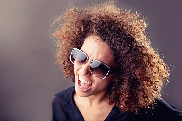 istock curly haired inspired young woman singing 624170280