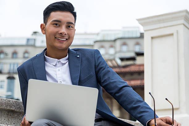 istock Smiling Asian man in the street. 624170302