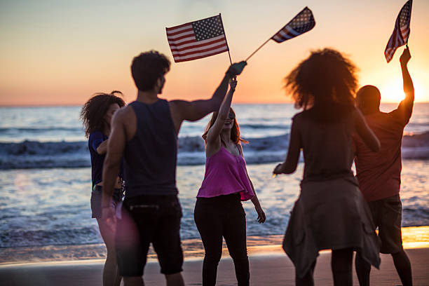 istock Friends celebrating independence day on the beach 624171096