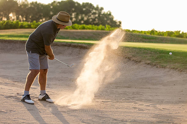 istock Senior Male Golfer Playing Bunker Shot On Golf Course 624171160
