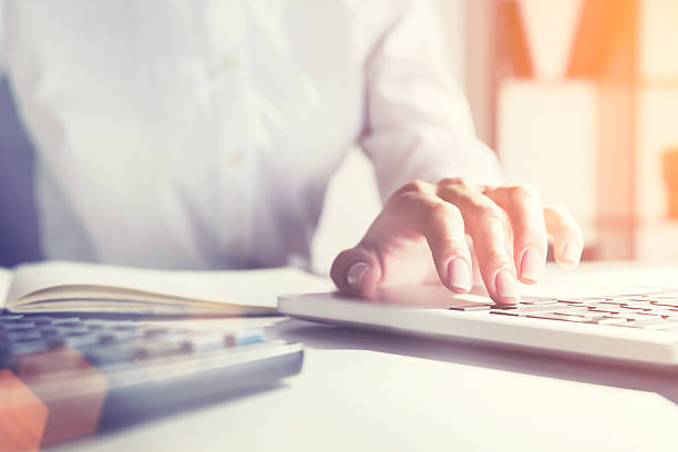 istock Woman in office who is typing with one hand 624171224