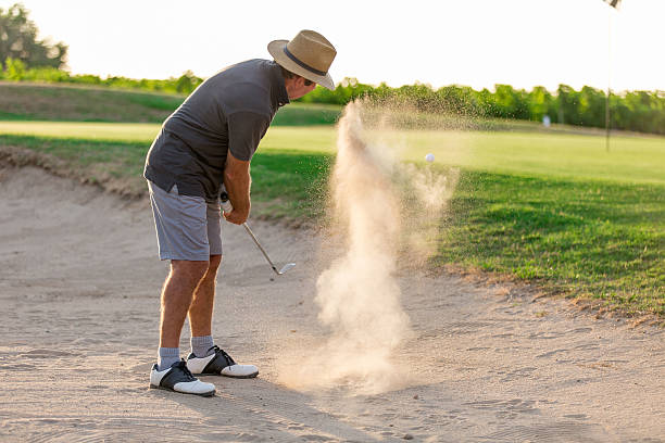 istock Senior Male Golfer Playing Bunker Shot On Golf Course 624171300