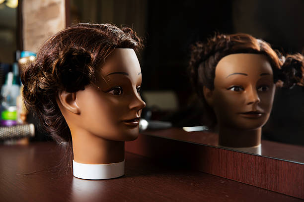 istock Hairdressing mannequin located on a wooden table. 624171616