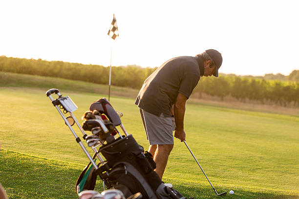 istock golfer on sunset with flares 624172326