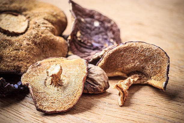 istock Dry mushrooms on wooden rustic table. 624178964