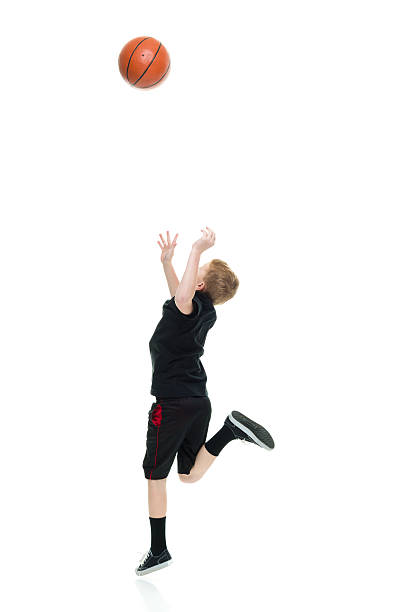 istock Little boy jumping with basketball 624179096