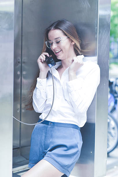 istock Joyful Young Woman Talking on a Payphone 624179306