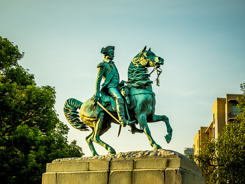 verdigris statue of George Washington riding his horse, on a concrete pedestal in Washington Circle, Washington, DC