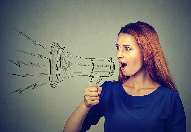 istock angry young woman screaming in megaphone 624180598