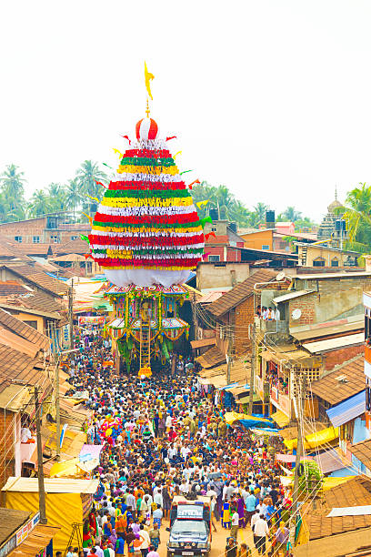 Gokarna, India - March 3, 2016: Crowd of people gather to pull the oversized ratta chariot during annual Shivarathri festival. Vertical high aerial view