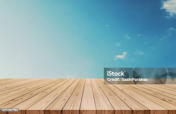 Wood Table Top On Gradient Blue Sky And White Clouds Stock Photo - Download Image Now
