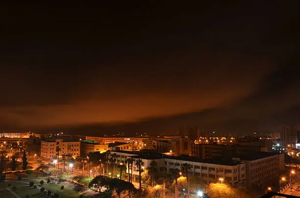 Photo of City buildings with dramatic sky at night