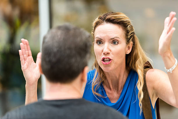Mature Couple arguing Mature Couple arguing, she is very upset screaming at him business criticism stock pictures, royalty-free photos & images