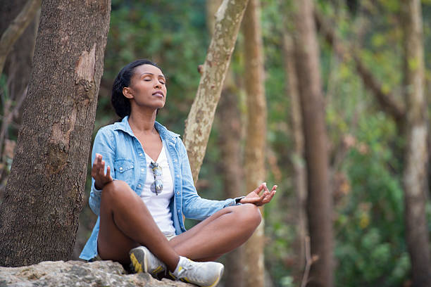 Woman meditating outdoors.
