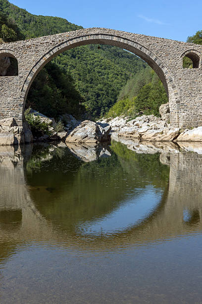 istock Reflection of Devil's Bridge and Rhodopes mountain in Arda river 624205756