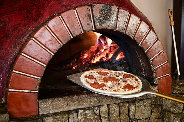 istock Italian pizza prepared in brick stove with fire flames 624205838
