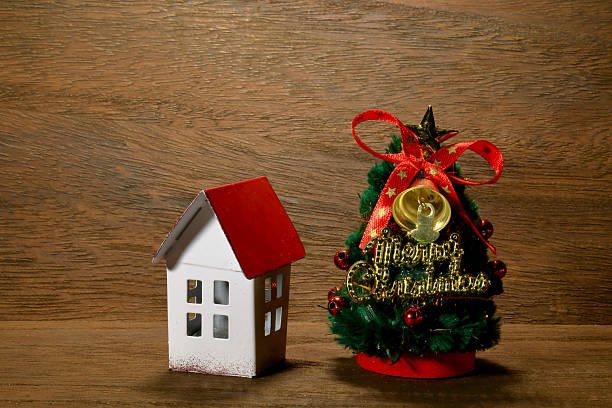 istock Christmas tree and red roof house 624207214