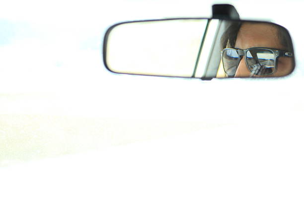 Close up of camera reflection in rearview mirror in the car, focus on reflection