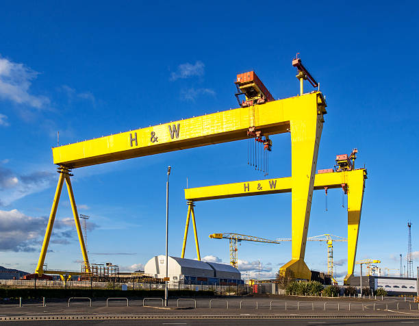 Samson and Goliath. Famous shipyard cranes in Belfast Belfast, Norther Ireland, United Kingdom - October 2, 2016: Samson and Goliath. Twin shipbuilding gantry cranes in Titanic quarter, famous landmark of Belfast, Norther Ireland. Goliath is in the foreground. belfast stock pictures, royalty-free photos & images