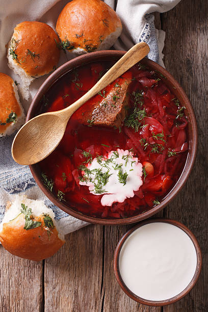 istock Ukrainian borsch soup and garlic buns close-up. vertical top view 624214072