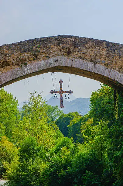 Detail on hanging cross in roman bridge of Cangas de Onis, Principado de Asturias, Spain