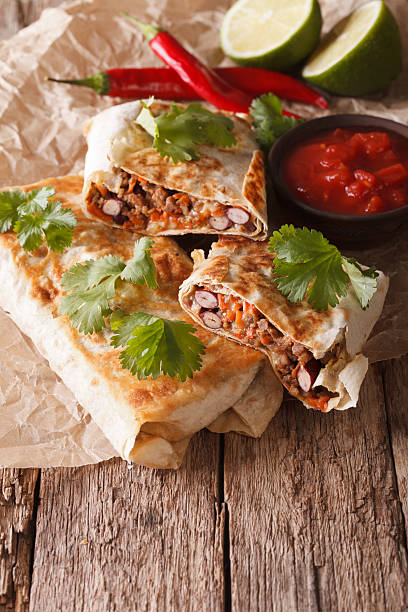 istock chimichanga with ground meat, beans and cheese macro. Vertical 624214958