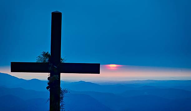 istock christian worship cross overlooking mountains at sunrise 624223694
